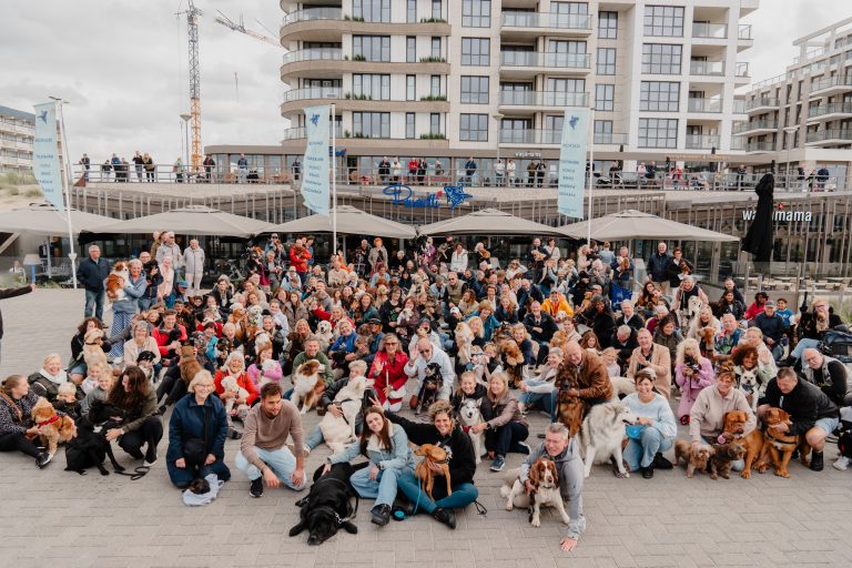 tientallen mensen met honden op boulevard in Nieuw Kijkduin
